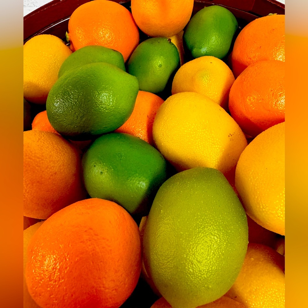 Basket of oranges, limes and lemons.